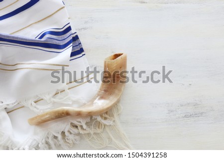 religion image of shofar (horn) on white prayer talit. Rosh hashanah (jewish New Year holiday), Shabbat and Yom kippur concept Royalty-Free Stock Photo #1504391258