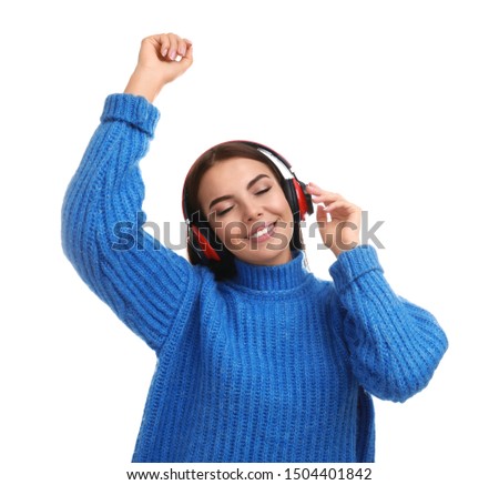 Young woman listening to music with headphones on white background