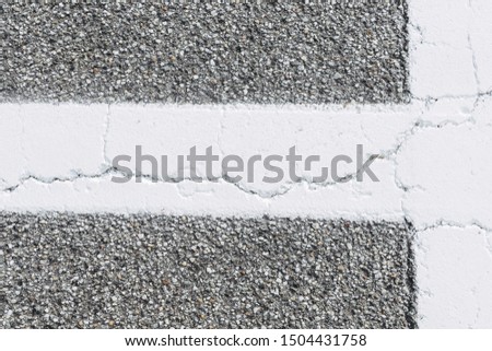 White lines on old cracked asphalt street, white painted as a traffic sign 
isolated background on road