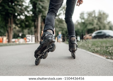 Roller skating, skater rolling, back view on legs Royalty-Free Stock Photo #1504436456