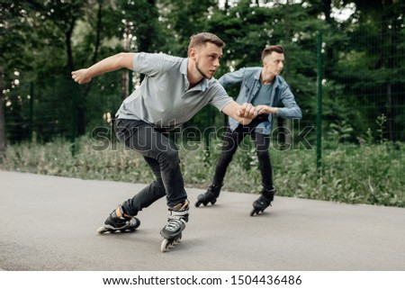 Roller skating, two male skaters begins speed race