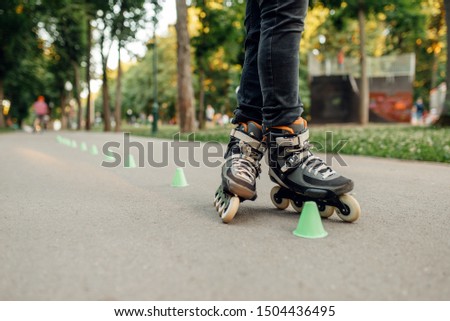 Roller skating, skater rolling around the cones