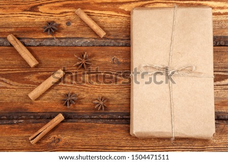 gift Packed in eco-friendly biodegradable cardboard on dark old wooden background with blank space for text. top view. flat lay