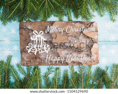 Brown and blue wooden Christmas background with fir branches, bark. Winter holidays concept