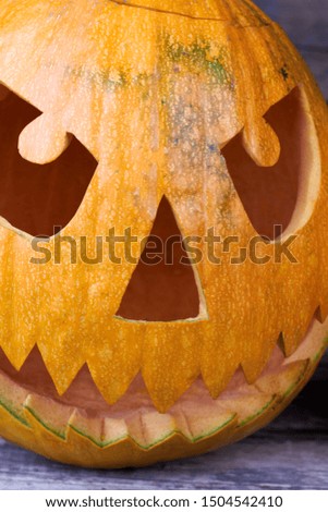 Close up carved pumpkin for Halloween. Halloween pumpkin with scary face. Easy pumpkin carving ideas.