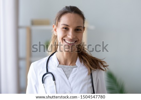 Head shot portrait smiling mixed race female doctor nurse in white uniform with stethoscope on neck, happy therapist physician practitioner woman looking at camera, healthcare concept
