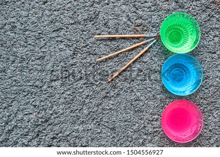 Set of water containers with different colors to clean used brushes, for watercolors and oil paints