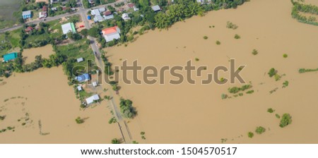 Aerial top view of Flooded rice paddies and the village, View from above shot by drone