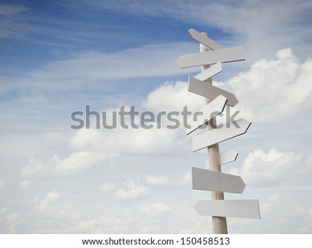 sign post with many arrows pointing on sky