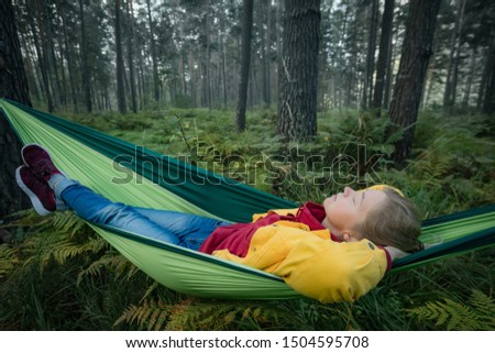 Woman resting in hammock outdoors. Sleeping outdoors. Relax time on holiday concept travel.