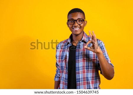 Young handsome man of african american ethnicity wearing checkered shirt posing over isolated background. Portrait of stylish confident male in casual outfit. Close up, copy space.