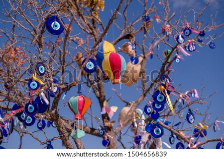Many glass mascots - evil eye charms hang from a tree in Cappadocia, Pigeon valley, Anatolia, Turkey