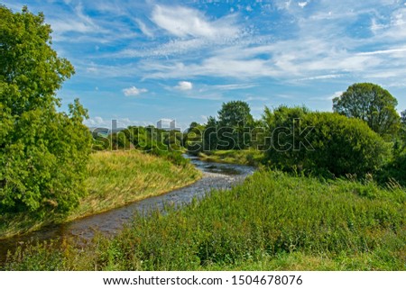 Summer river with bright blue sky, clouds and trees, Scotland