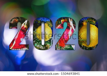 2020. New year background. The numbers 2020. Christmas decoration. Christmas background.Christmas toys, red and yellow balls on a bokeh background with blue and green colors. Copy space