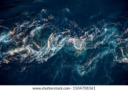 Waves of water of the river and the sea meet each other during high tide and low tide. Whirlpools of the maelstrom of Saltstraumen, Nordland, Norway Royalty-Free Stock Photo #1504708361