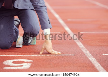 A businessman on a track ready to run  Royalty-Free Stock Photo #150474926