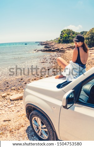 woman laying at car hood with view of sea summer beach vacation copy space