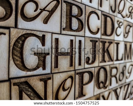 neat and engraved alphabet on aged wood
