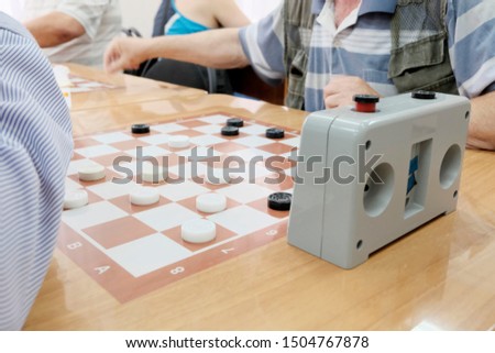 Chess Board with checkers. Game concept. Board game. Hobbies, checkers on the playing field for the game. Older men play