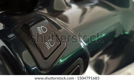 closeup motorcycle handle with headlight switch