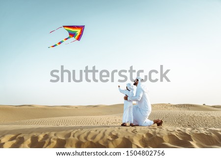 Father and son spending time in the desert Royalty-Free Stock Photo #1504802756