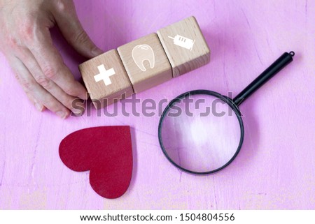 Doctor hand arranging wood block stacking with icon health care search medical, insurance for your health concept.