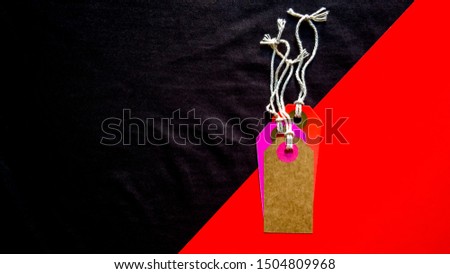 Blank tag for show price or discount on a red and black diagonal background separated. Price tags, cardboard tags in brown, purple, red. Background, holiday concept. Black Friday - International Day