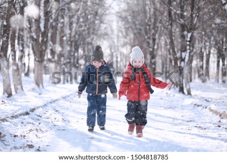 Kids walk in the park with first snow Royalty-Free Stock Photo #1504818785