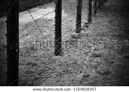 Fence for forbidden area or control border strip with barbed wire fence in vintage style photograph
