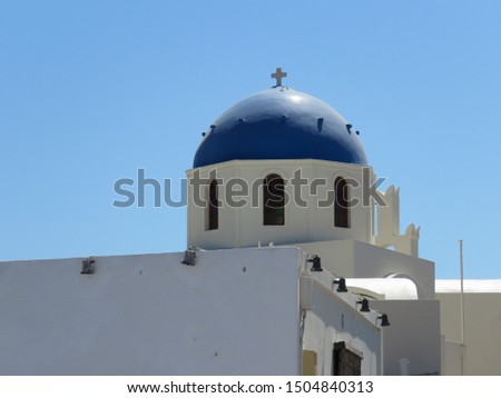 The famous blue domes on the cubiform whitewashed buildings, in the Greek Village of Oia on the Island of Santorini. Royalty-Free Stock Photo #1504840313