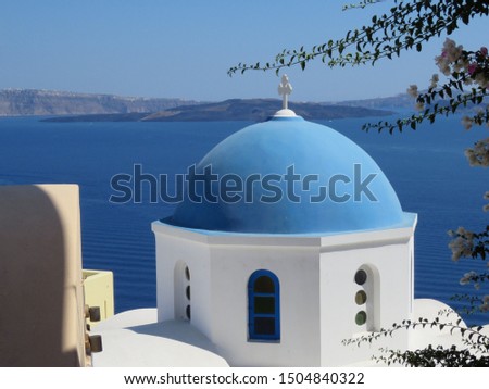 The famous blue domes on the cubiform whitewashed buildings, in the Greek Village of Oia on the Island of Santorini. Royalty-Free Stock Photo #1504840322