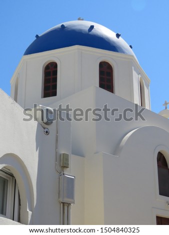 The famous blue domes on the cubiform whitewashed buildings, in the Greek Village of Oia on the Island of Santorini. Royalty-Free Stock Photo #1504840325