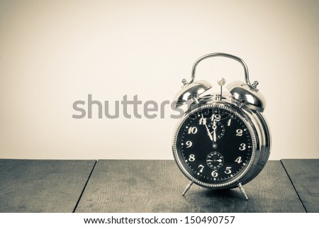 Vintage background with retro alarm clock on table Royalty-Free Stock Photo #150490757