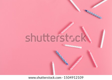 Birthday or party card composition. Pattern made of candle cake on pastel pink background.  Flat lay, top view, copy space