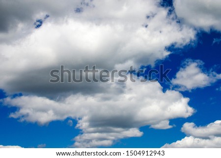 White fluffy clouds in a dark blue sky