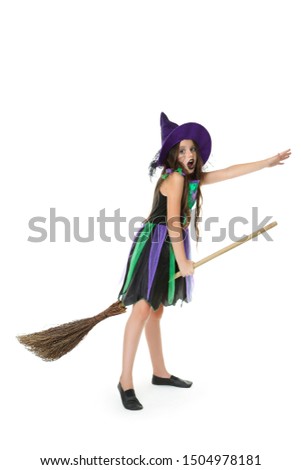 Beautiful girl in halloween costume with broom on white background