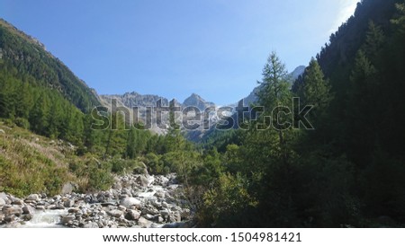 View on Trient Glacier and surrounding peaks from the valley on a bright sunny Summer day in Swiss Alps