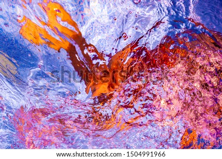 Joyful abstract picture. Colorful reflections on the water. Happy fun in the transparent blue water. Child floating underwater in the pool. View of a person diving and playing in the water. 