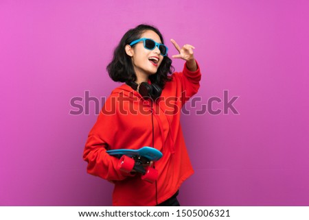 Asian young girl with skate over purple background