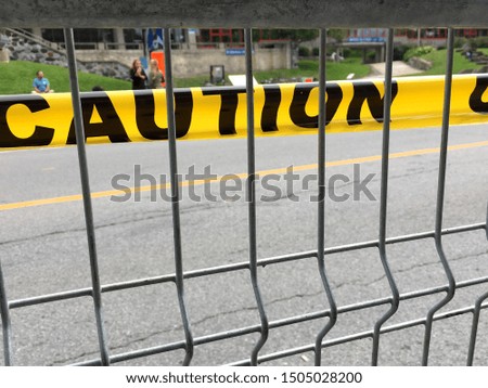 A yellow police tape Caution attached to the mesh fence by the boulevard limiting access to Grand Prix Cyclistes Montreal, on 15 September 2019.