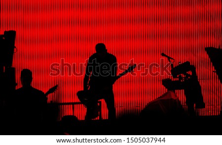 silhouette of a guitarist on stage during concert