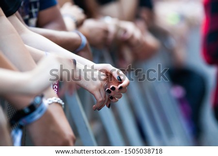 hands of fans waiting for a concert, hipsters, rock fans
