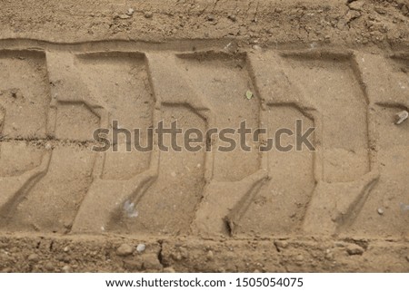 sand surface, a truck wheel pattern on a yellow sand, repair and reconstruction 