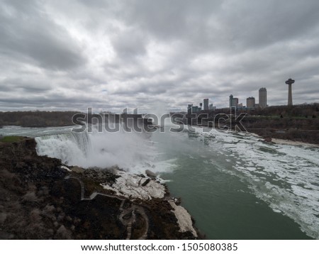 Panoramic view of the canadian and american Niagara Falls, Ontario skyline in the background stairs to the bottom of the falls in the foreground