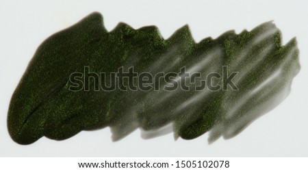 Sparkle green paint stain isolated on white background close up view