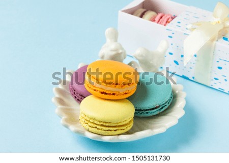 Colorful macaroons  on white plate. Gift box with macaroons.