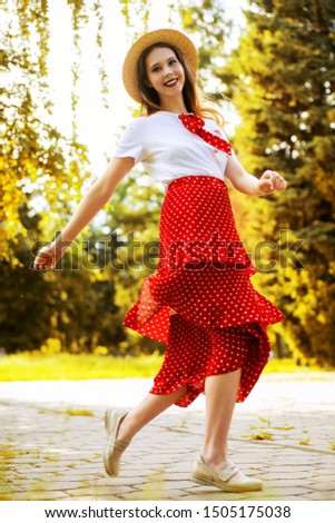 A  full length portrait of a cute romantic girl walking in the park. Summer casual fashion, beauty.