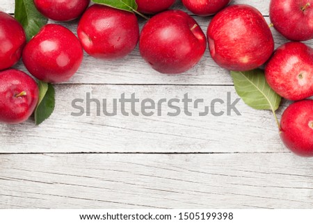 Ripe red apples on wooden table. Top view with copy space