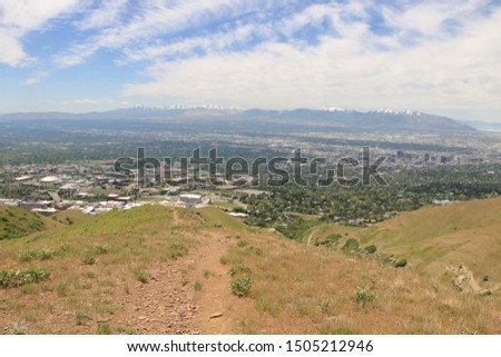Trail through grassy foothills looking down on Salt Lake City, Utah