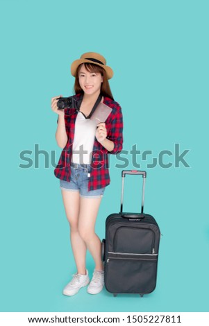 Beautiful portrait young asian woman with luggage smiling and travel summer trip for abroad in vacation, happy asia girl holding camera and passport with suitcase for journey with cheerful in holiday.